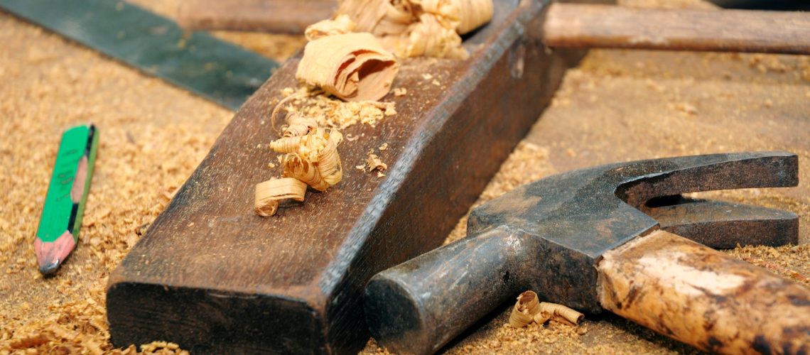 Closeup of carpentry tools on wooden table.